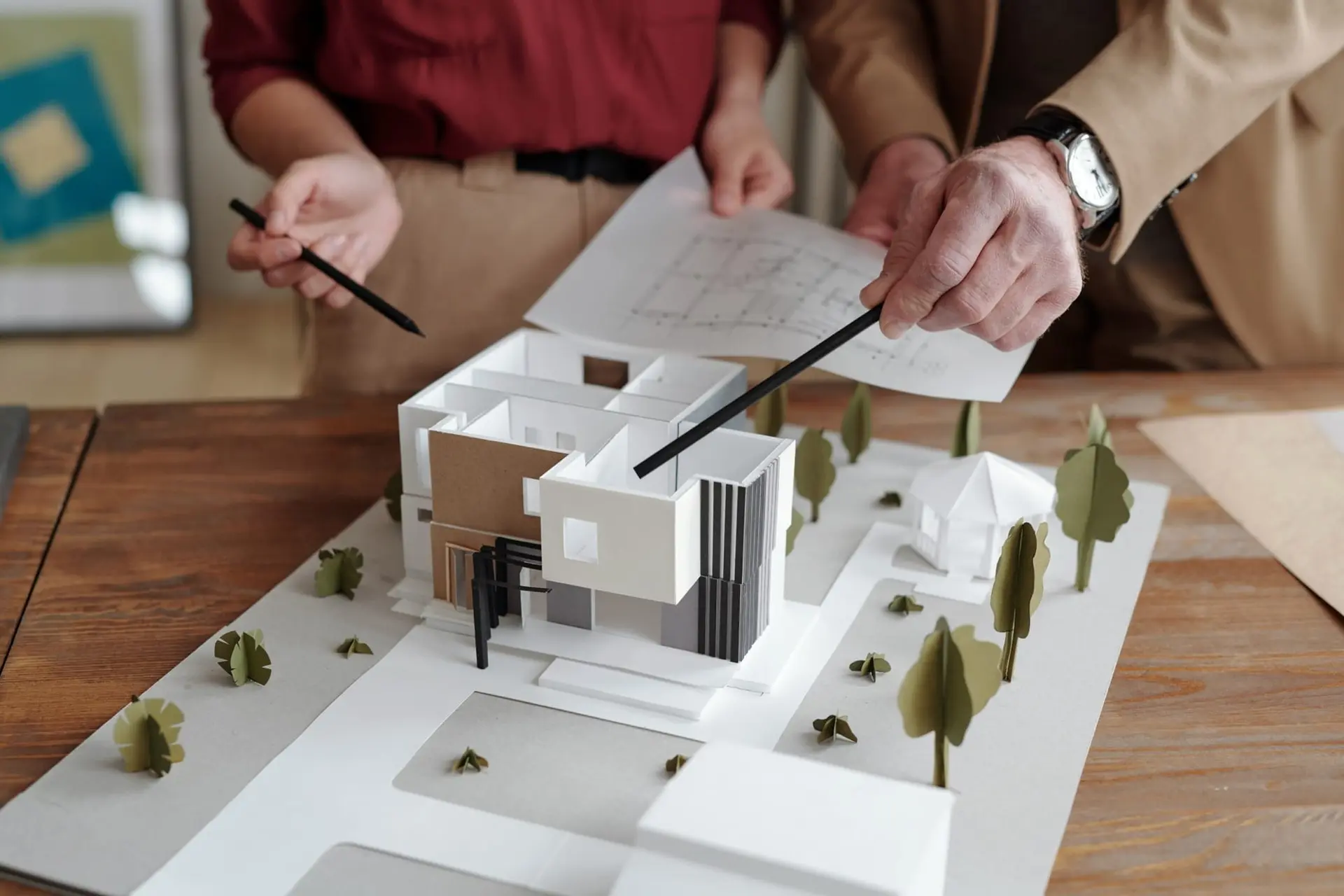Architects reviewing a scale model of a house